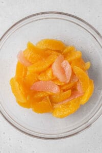 Orange and grapefruit segments in a glass bowl.
