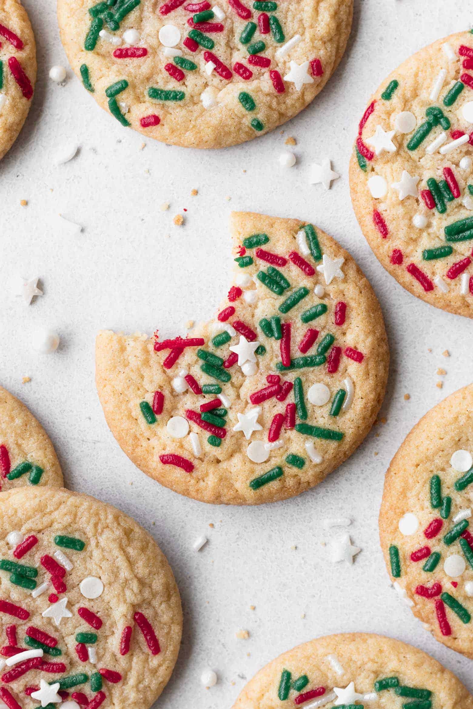 A Christmas sugar cookie with a bite taken out.