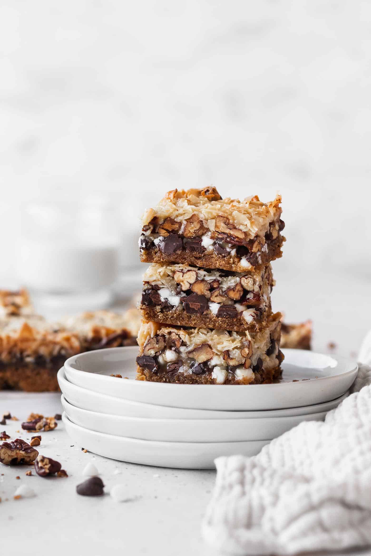 A stack of vegan magic bars on white plates.