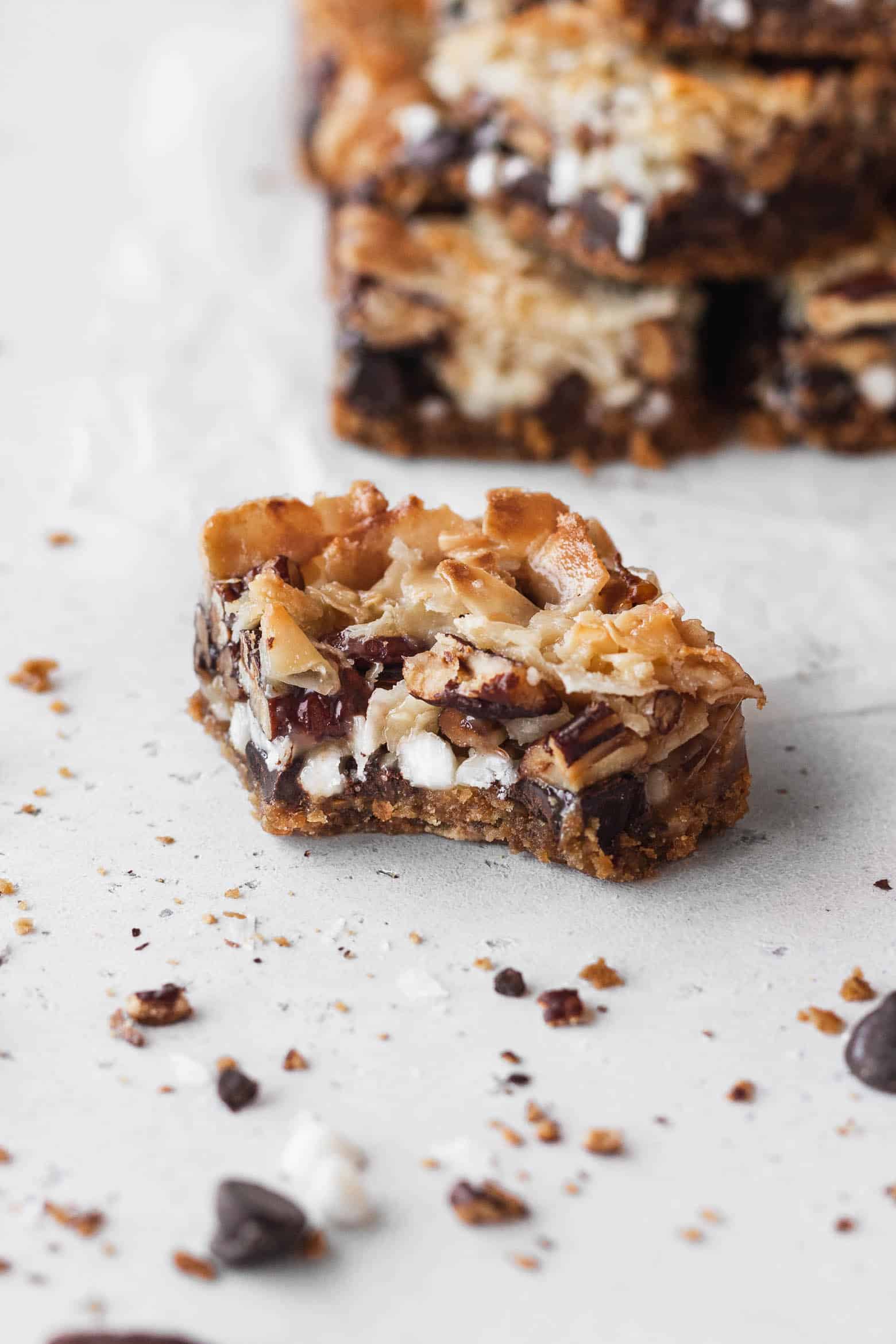 A bitten piece of vegan 7 layer bars.