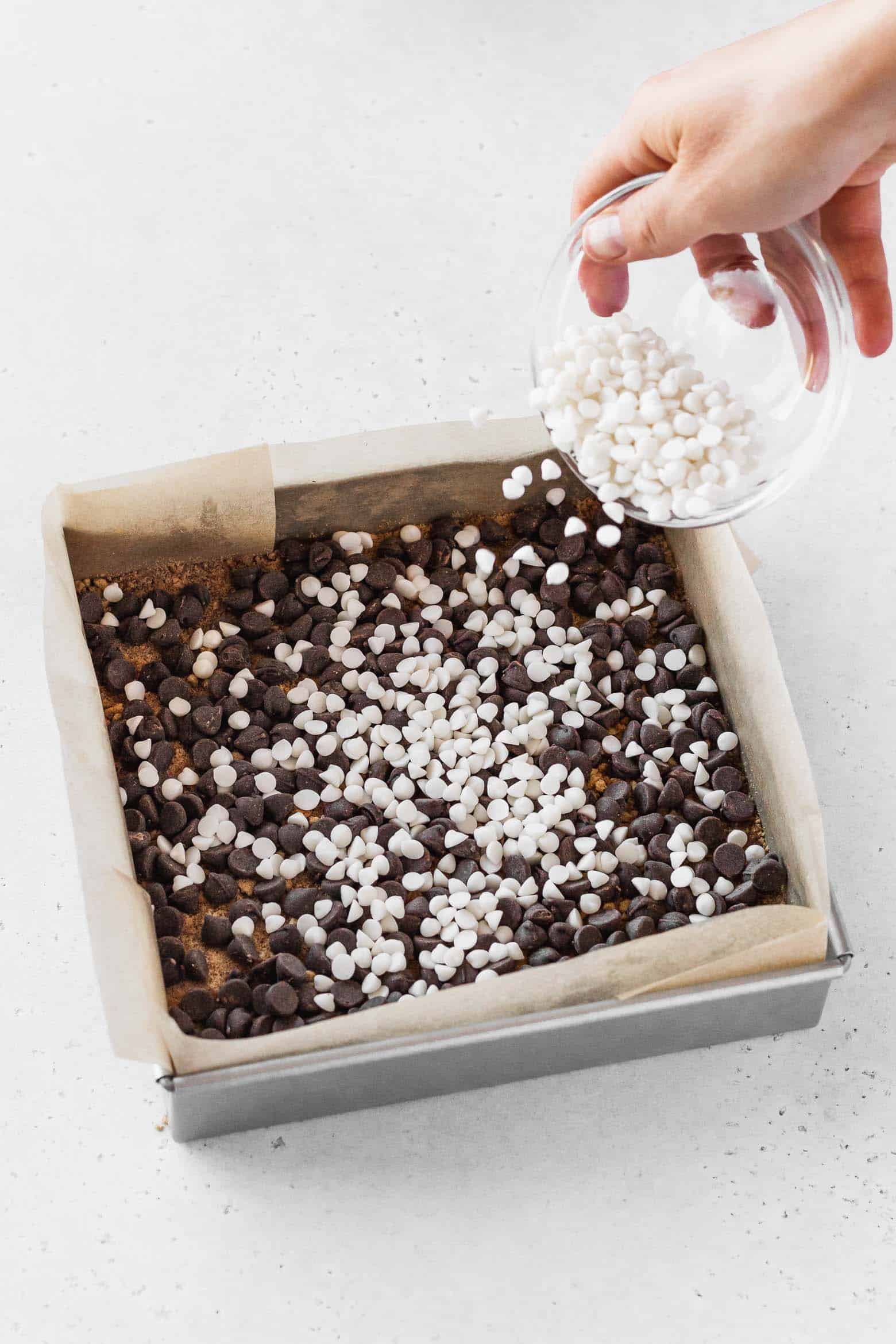 Adding a layer of vegan chocolate chips over the graham cracker layer.