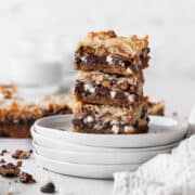A stack of vegan magic bars on white plates.