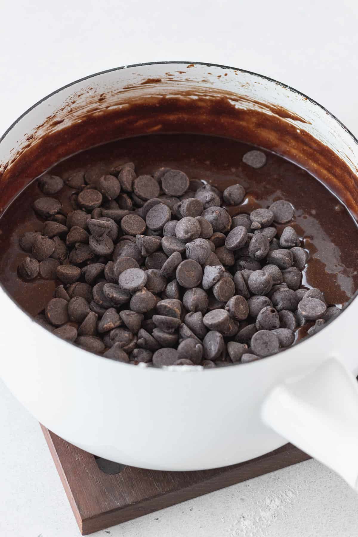 Chocolate chips getting folded into brownie batter.