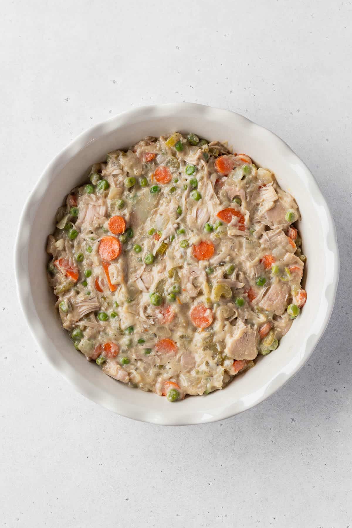 Overhead shot of a ceramic pie dish filled with vegan pot pie filling.