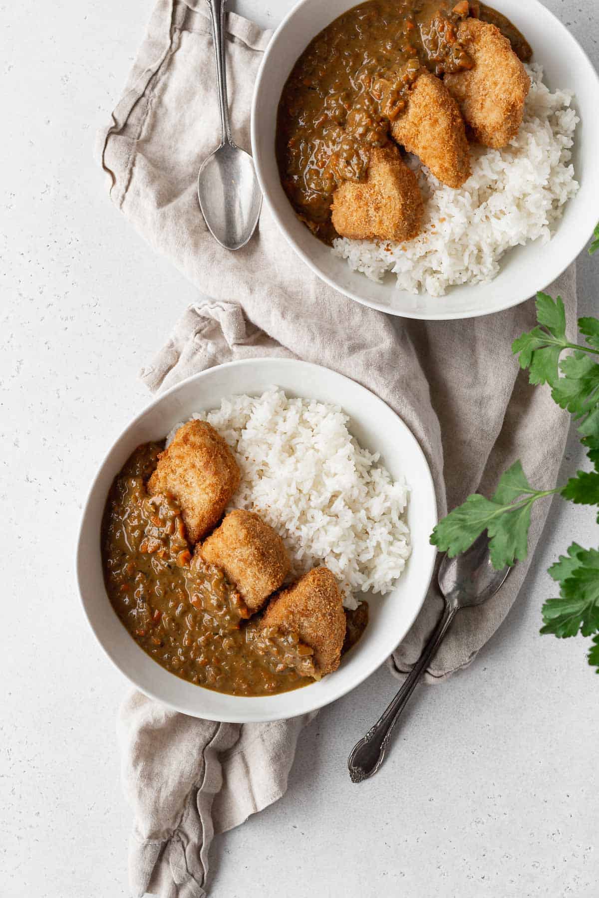 Overhead shot of 2 bowls of Japanese vegan katsu curry with rice.