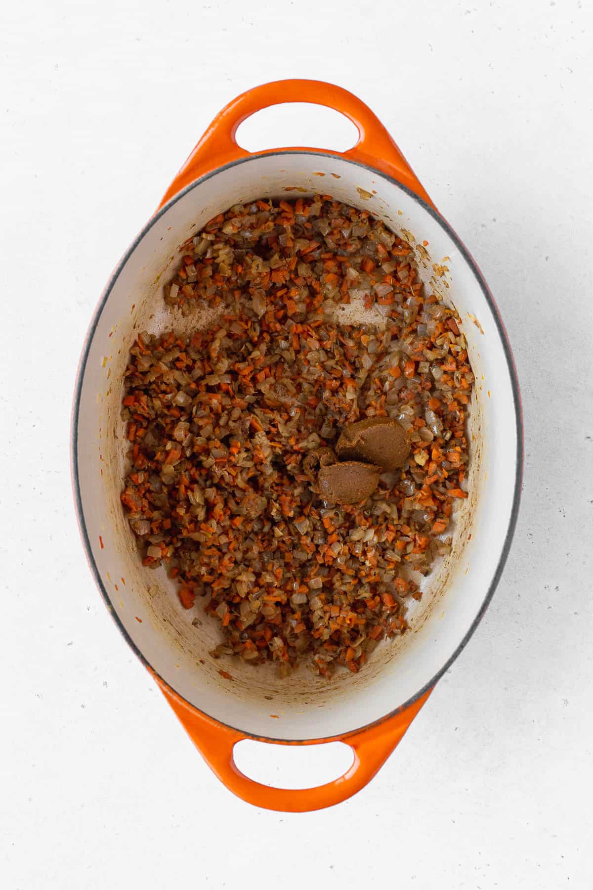 Yellow curry paste added to the sautéed vegetables.