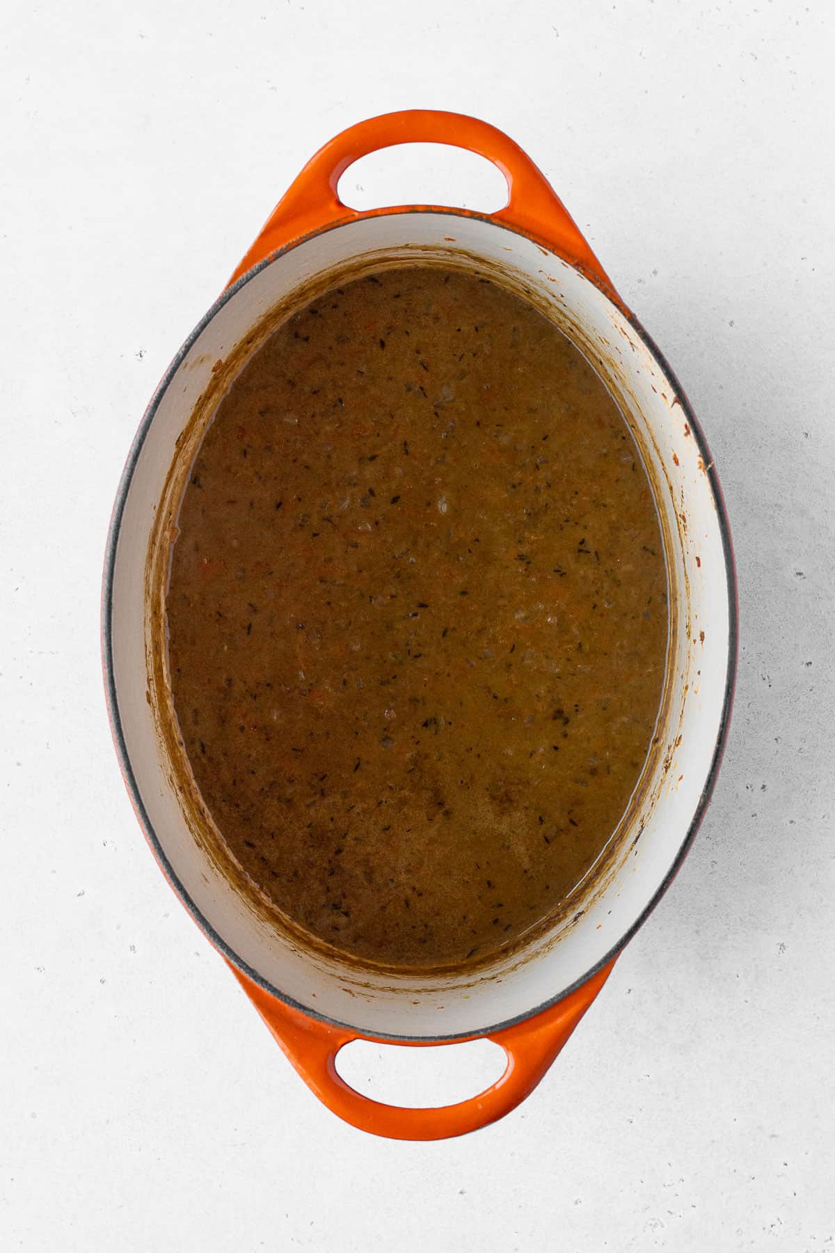 Vegan Japanese curry in a pot with orange handles.