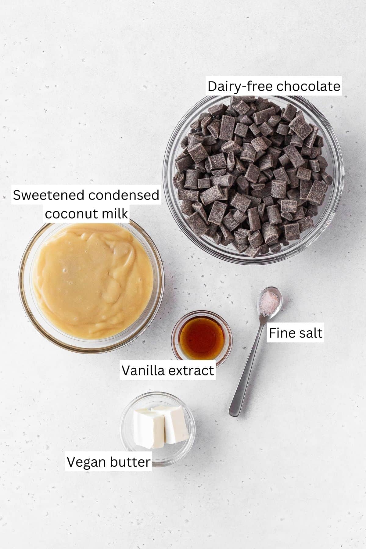 Ingredients for making dairy-free fudge measured out onto a white table with text overlay.