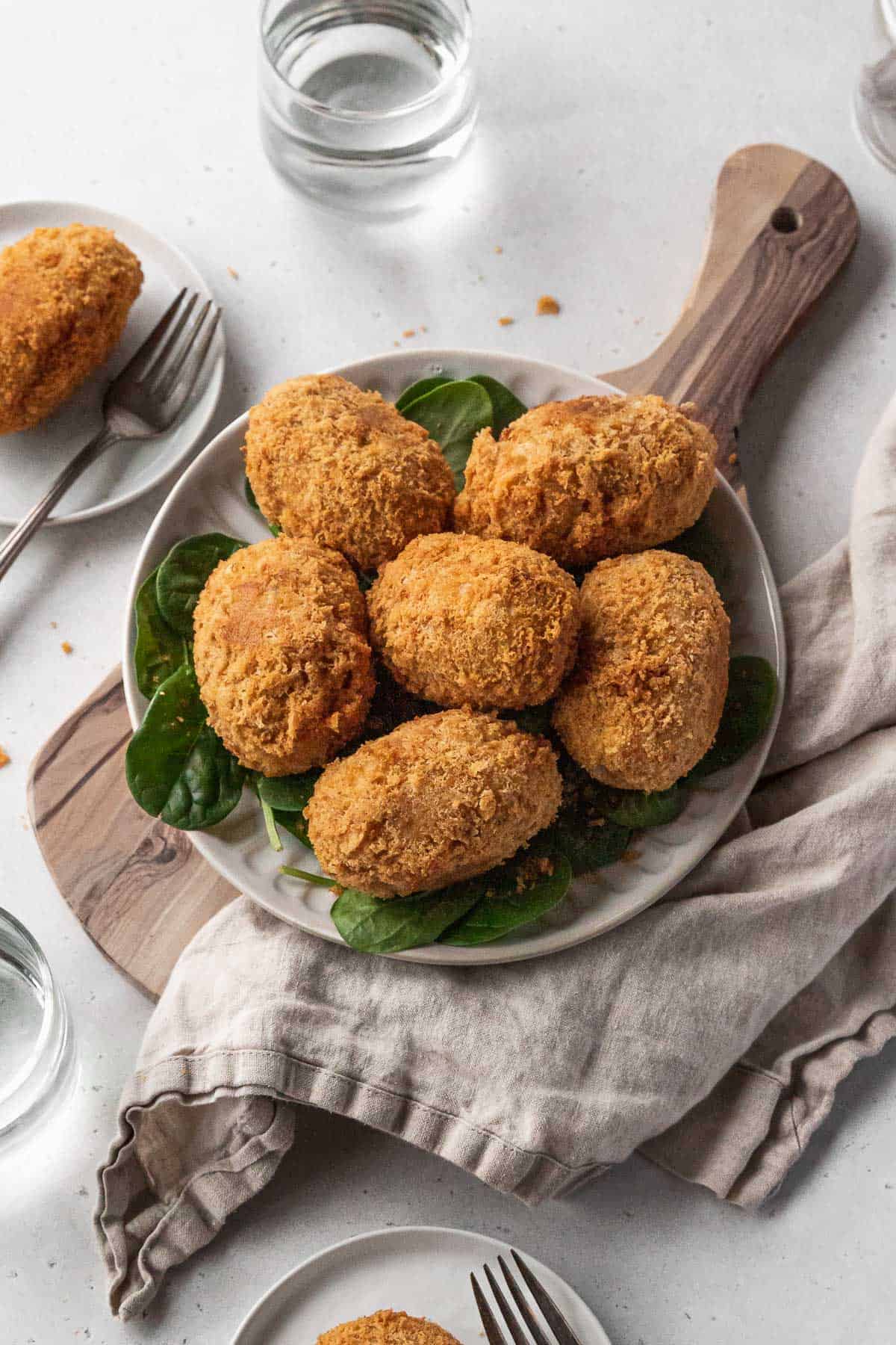 Closeup on serving platter of vegan potato croquettes.