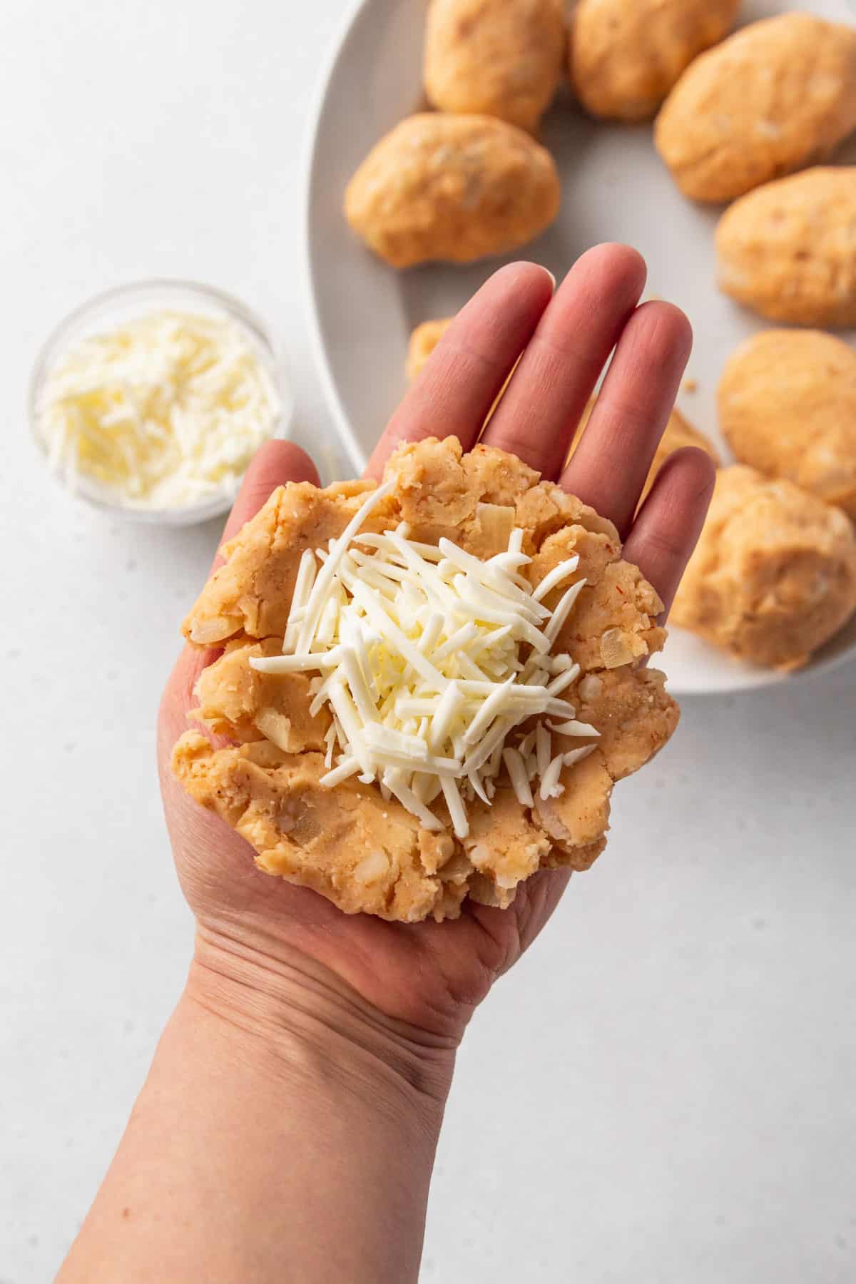 Shredded vegan cheese added to the center pocket of the potato croquette dough.