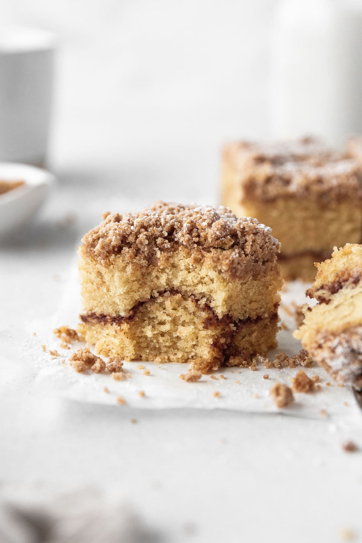 A square of gluten-free coffee cake with a bite taken out.