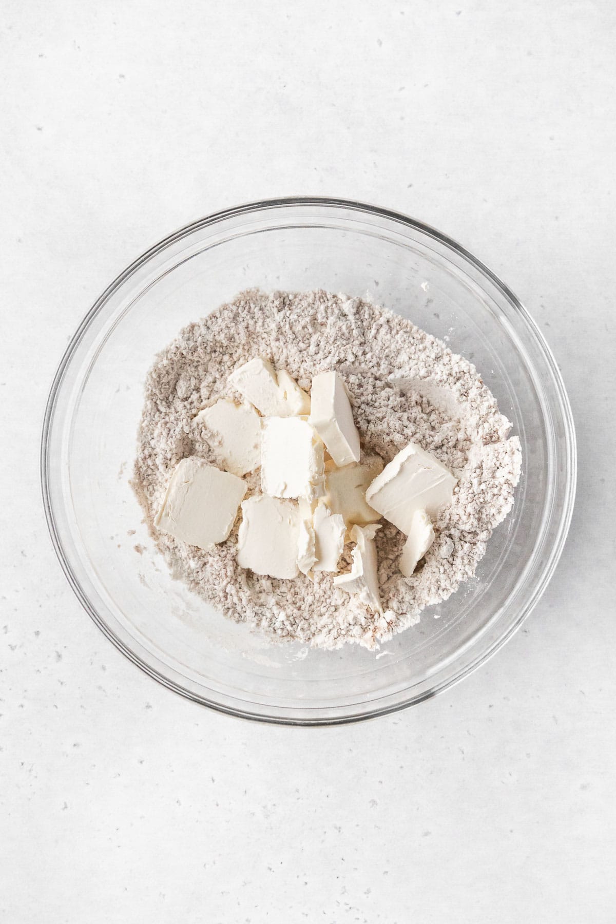 Squares of butter and dry ingredients for making coffee cake topping.