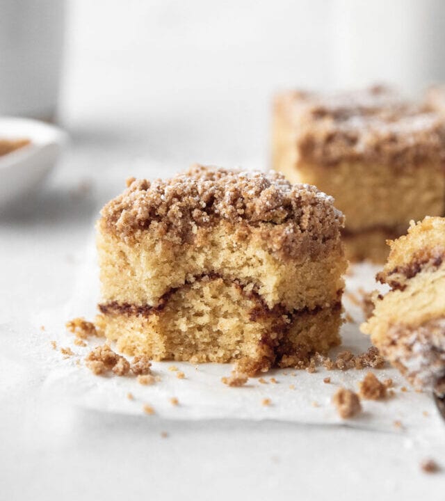 Closeup shot of a square of gluten-free coffee cake with a bite taken out.