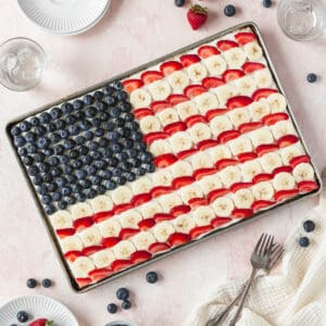 A square image of the entire sheet pan of gluten free and dairy free American flag dessert pizza with blueberries, bananas, and strawberries.