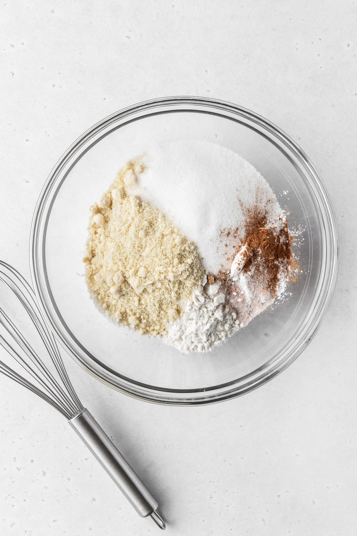 Dry ingredients for making dairy free gluten free vegan baked donuts in a mixing bowl.