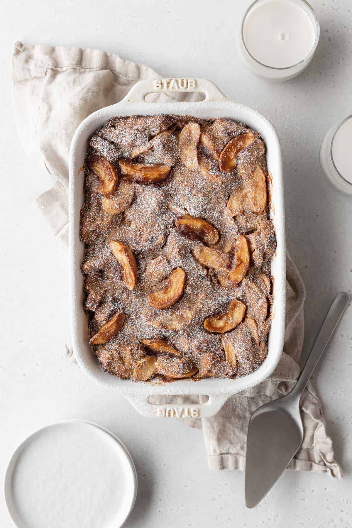 Overhead shot of a casserole dish filled with apple pie-flavored vegan bread pudding. 