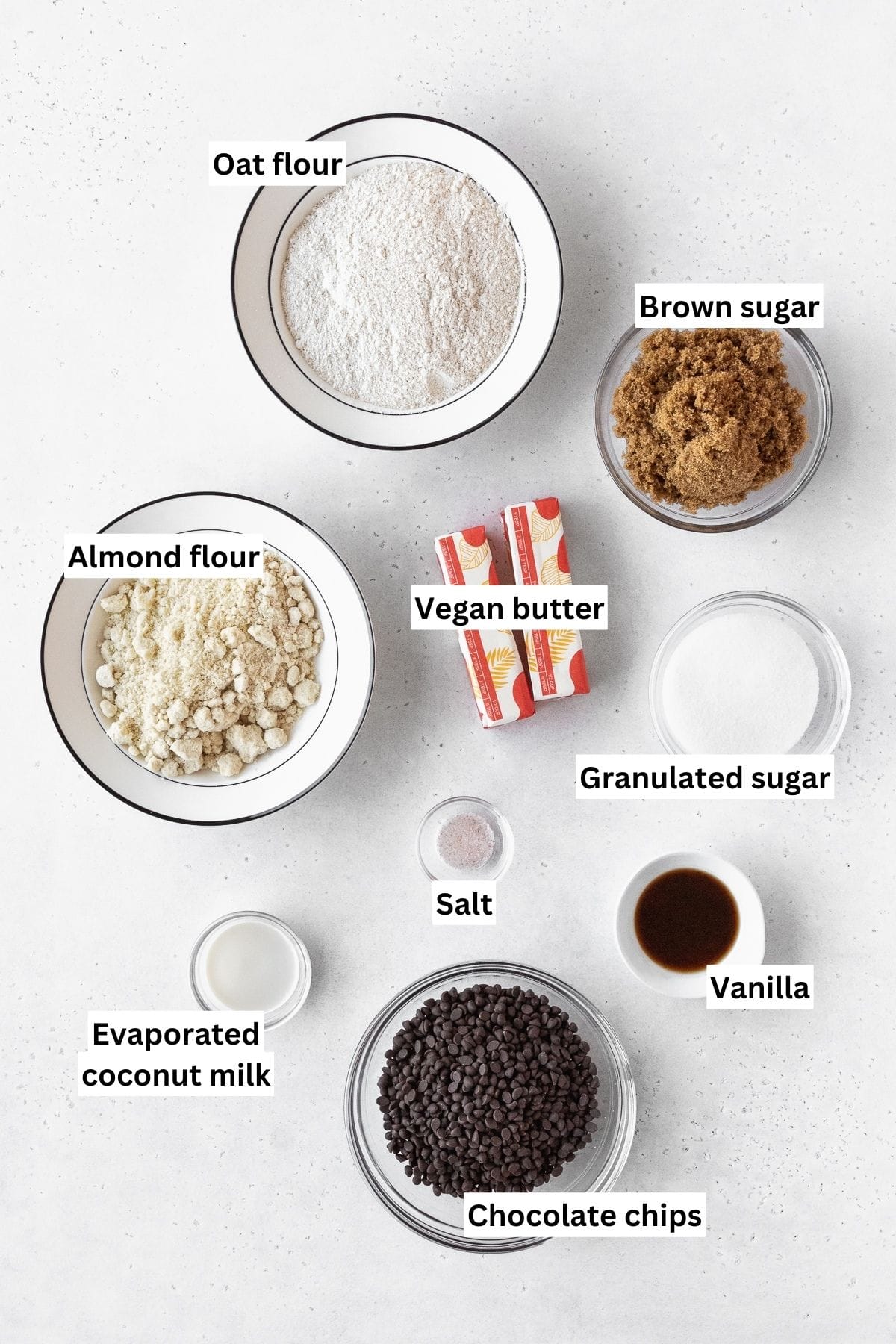 Ingredients needed to make gluten-free edible sugar cookie dough measured out on a white table.