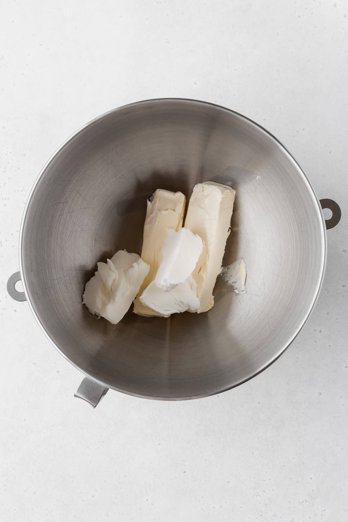 Adding the butter and shortening to the mixer bowl for lemon buttercream.
