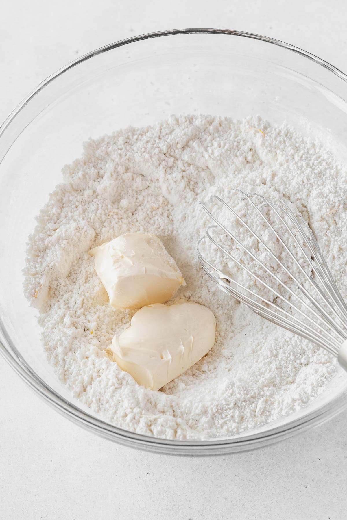 Mixing softened butter into the dry ingredients.