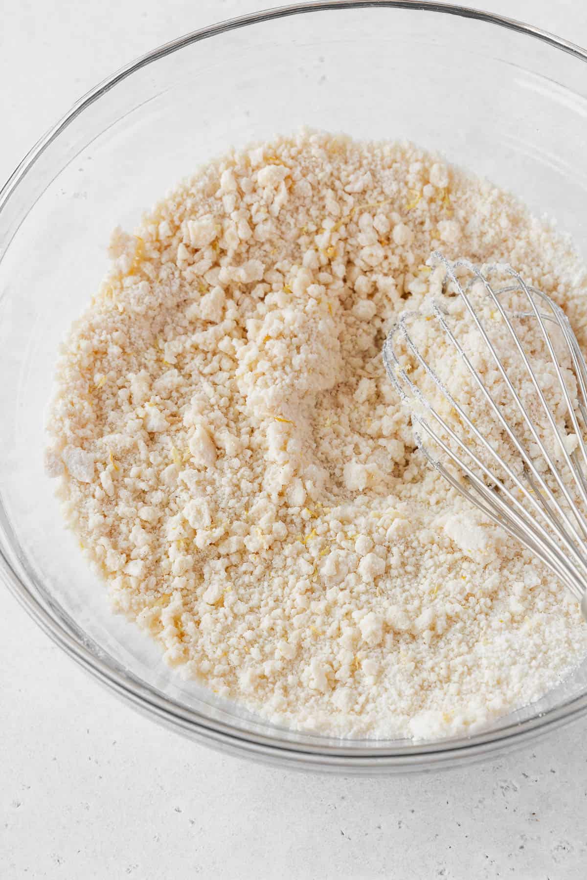 The mixture looks like wet sand after whisking in the butter.