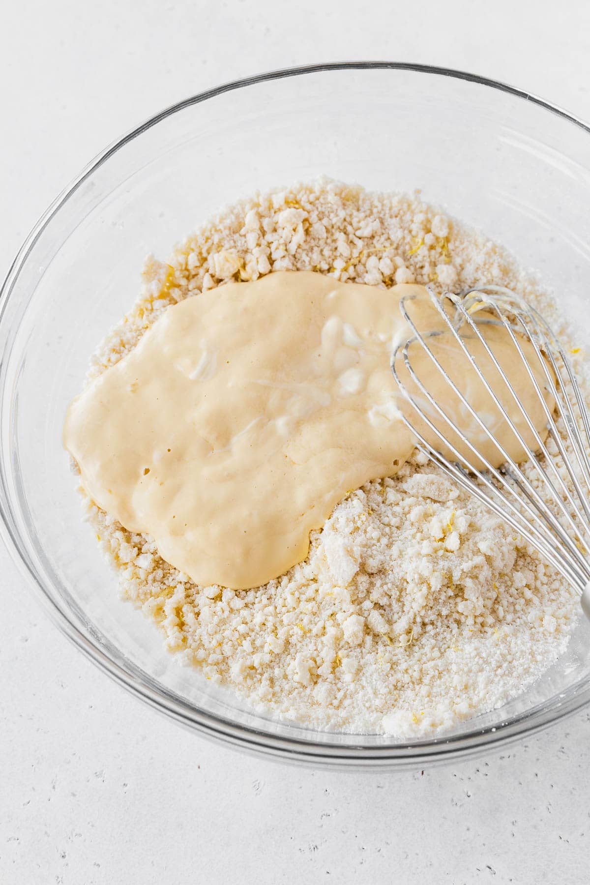Wet ingredients added to dry ingredients for the lemon layer cake recipe.