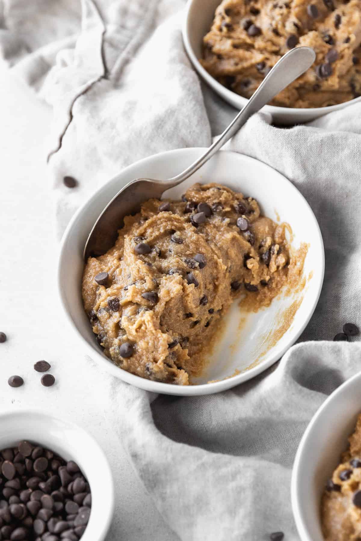 45 degree angle shot of a half-eaten bowl of dairy-free gluten-free edible cookie dough.