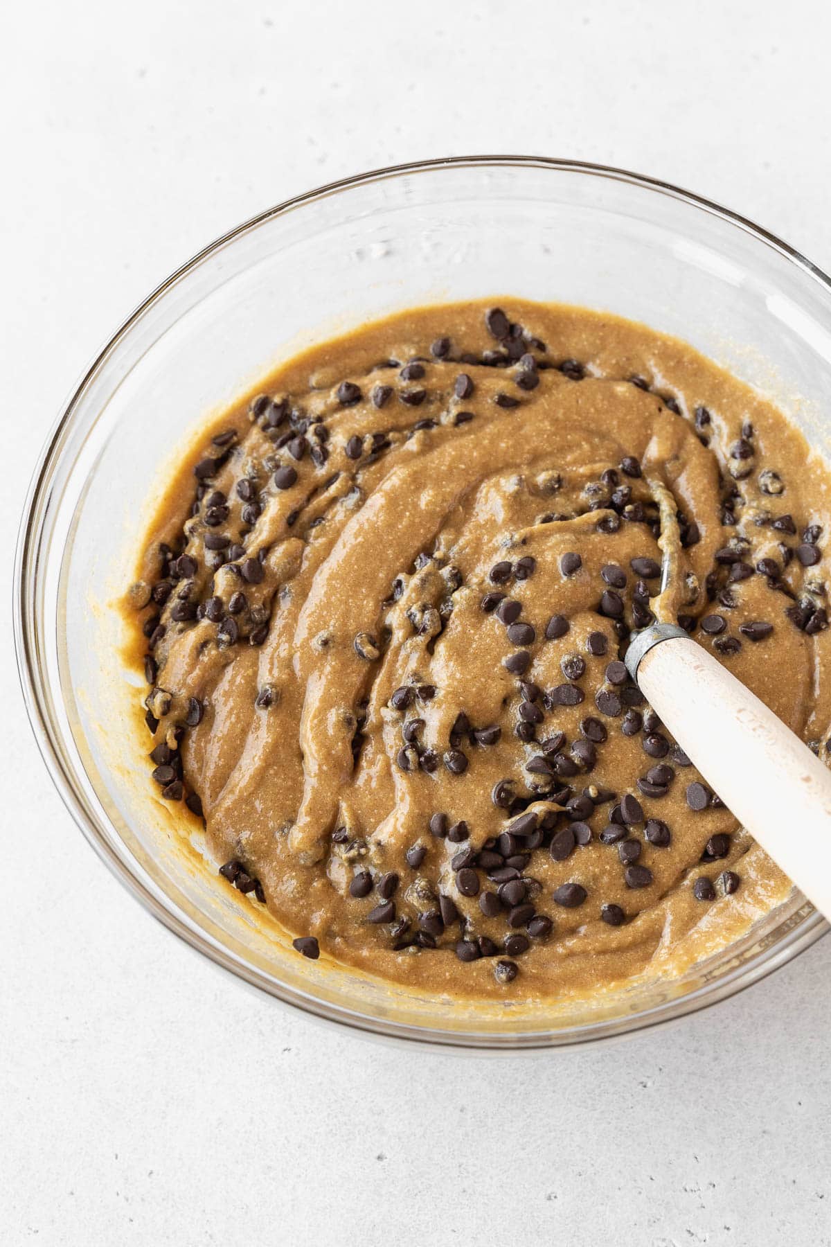 Step 3 for making gluten-free edible cookie dough — whisking in mini chocolate chips.