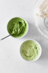 Two small ramekins with matcha frosting.