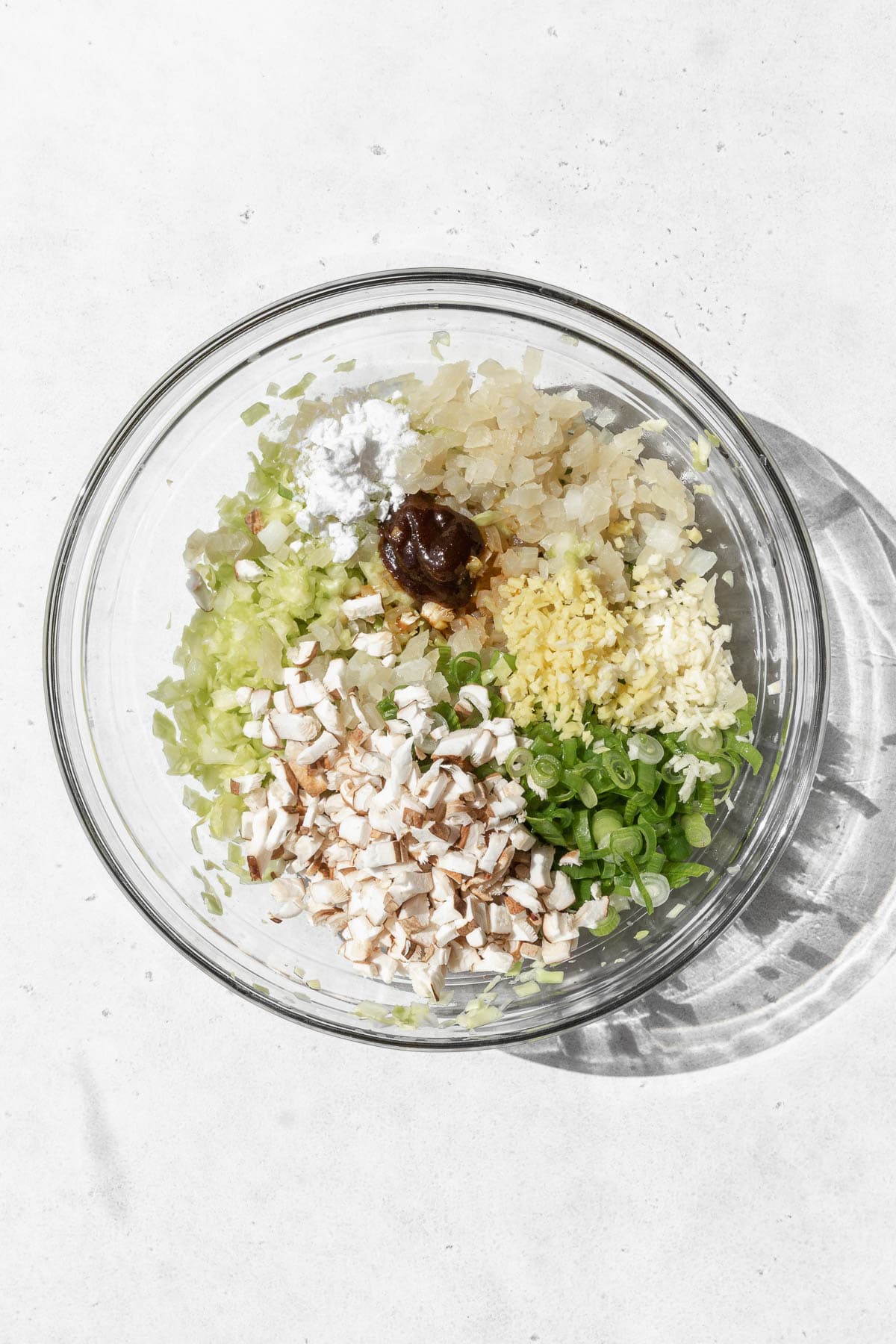 Ingredients for vegan dumpling filling in a large bowl.