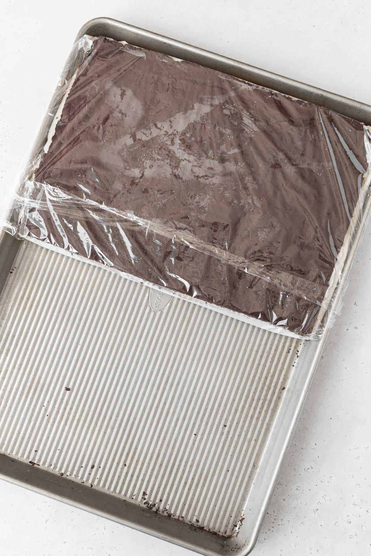 Stacking the gluten-free ice cream sandwich cookie together on a large cookie sheet.