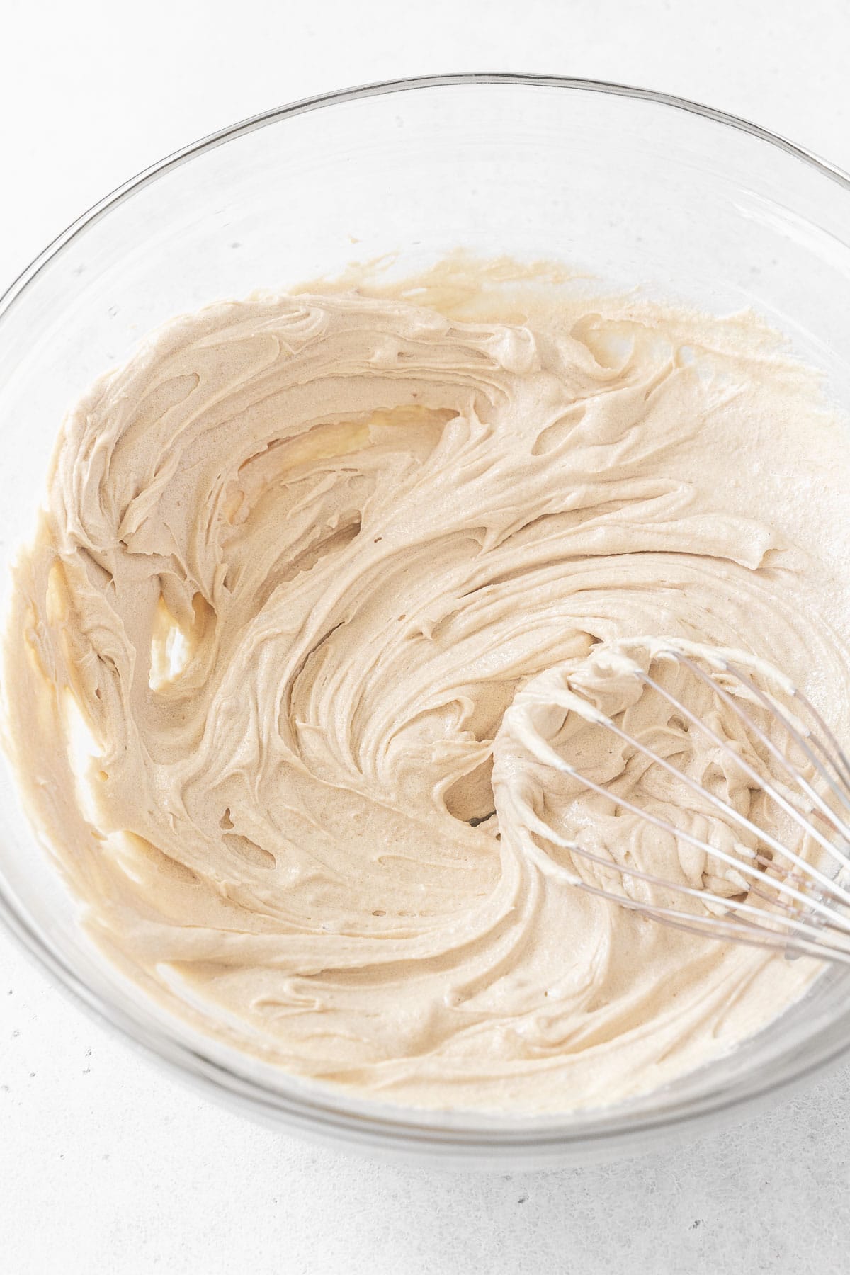 Butter and sugar beat together in a glass mixing bowl.