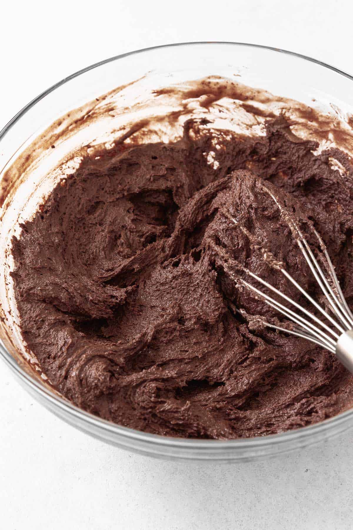 The chocolate sandwich cookie batter in a glass mixing bowl.