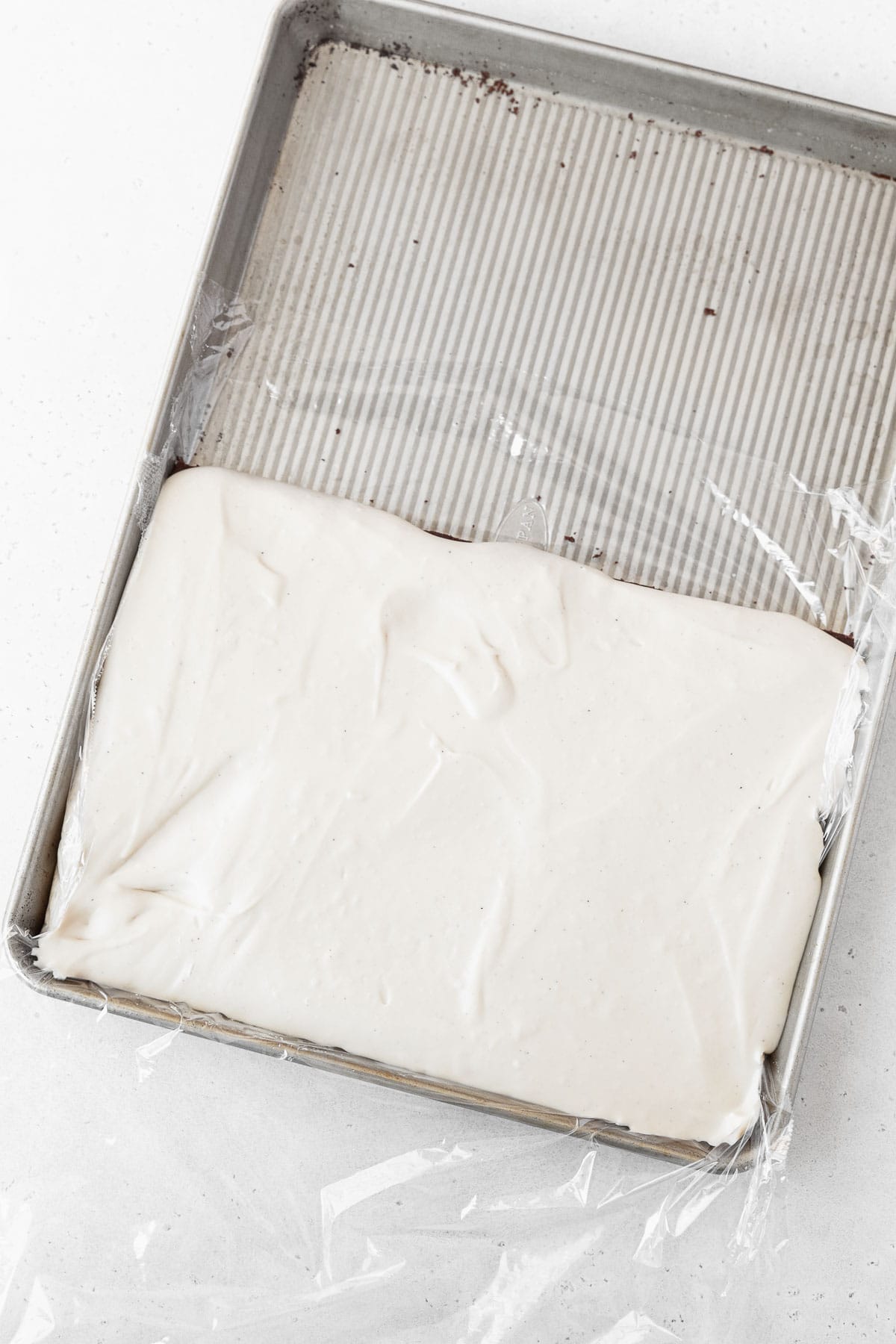 Spreading the dairy-free ice cream on the bottom half of the gluten-free ice cream sandwich cookie.