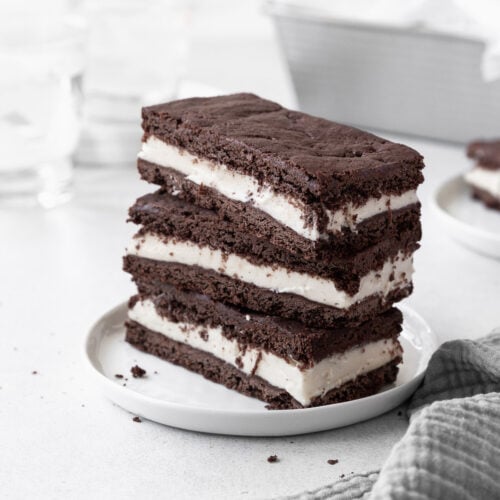 A stack of gluten-free ice cream sandwiches on a small white plate.