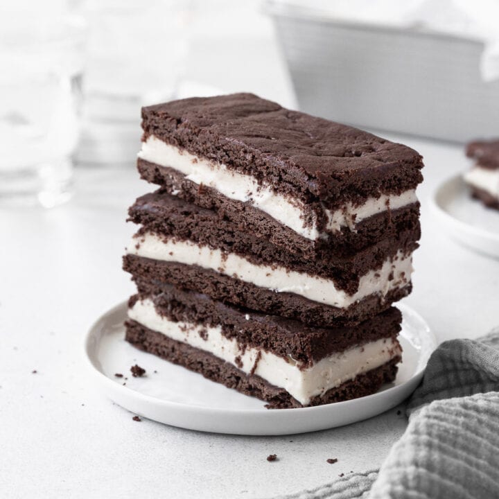 A stack of gluten-free ice cream sandwiches on a small white plate.