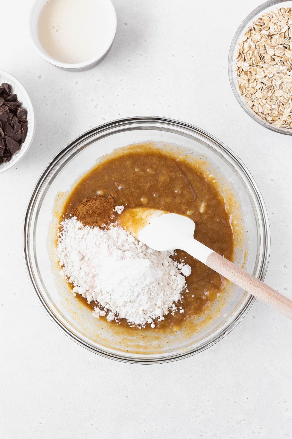 Stirring flour into the peanut butter and banana wet ingredients.