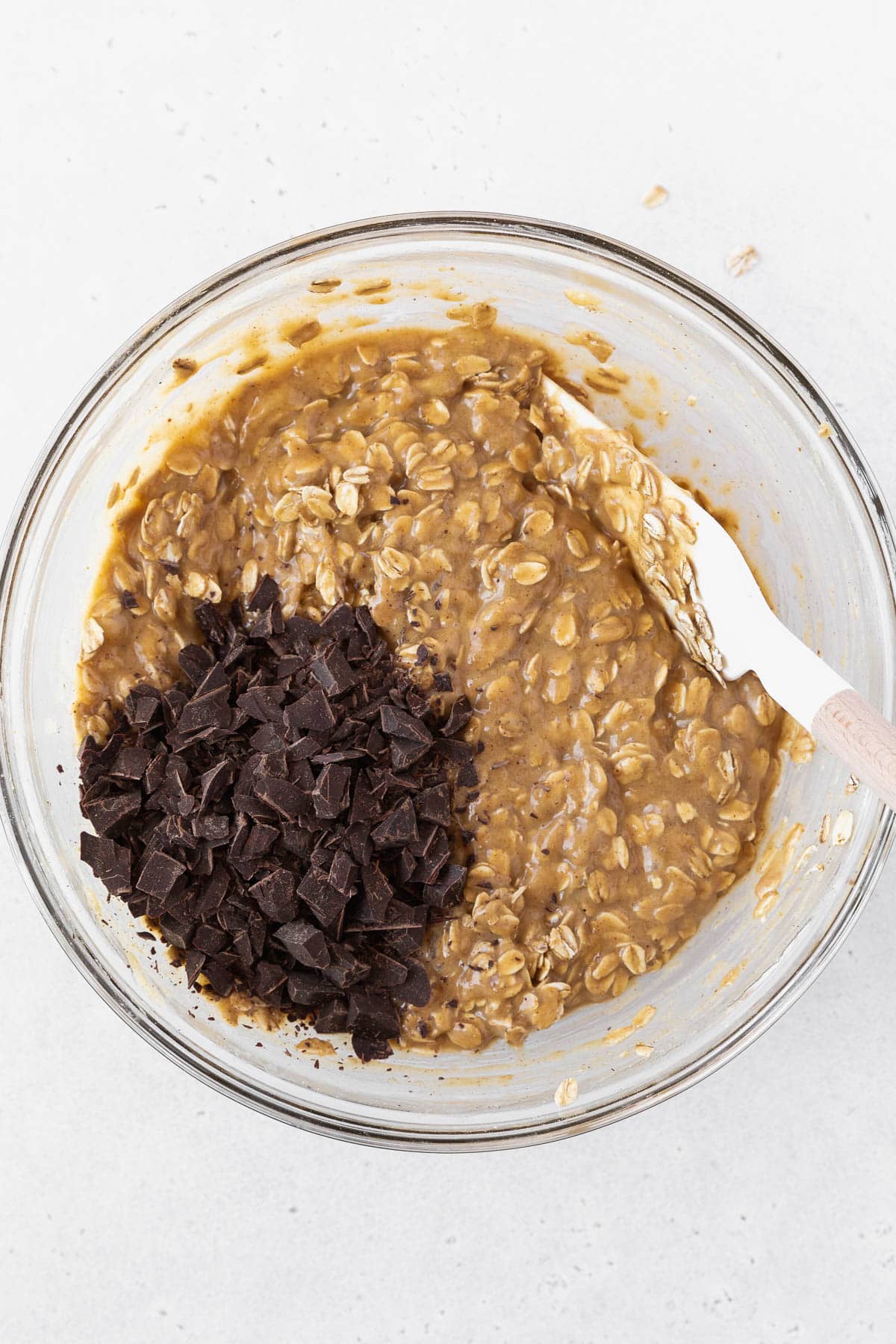 Stirring the shaved chocolate into the peanut butter banana oatmeal bar batter.