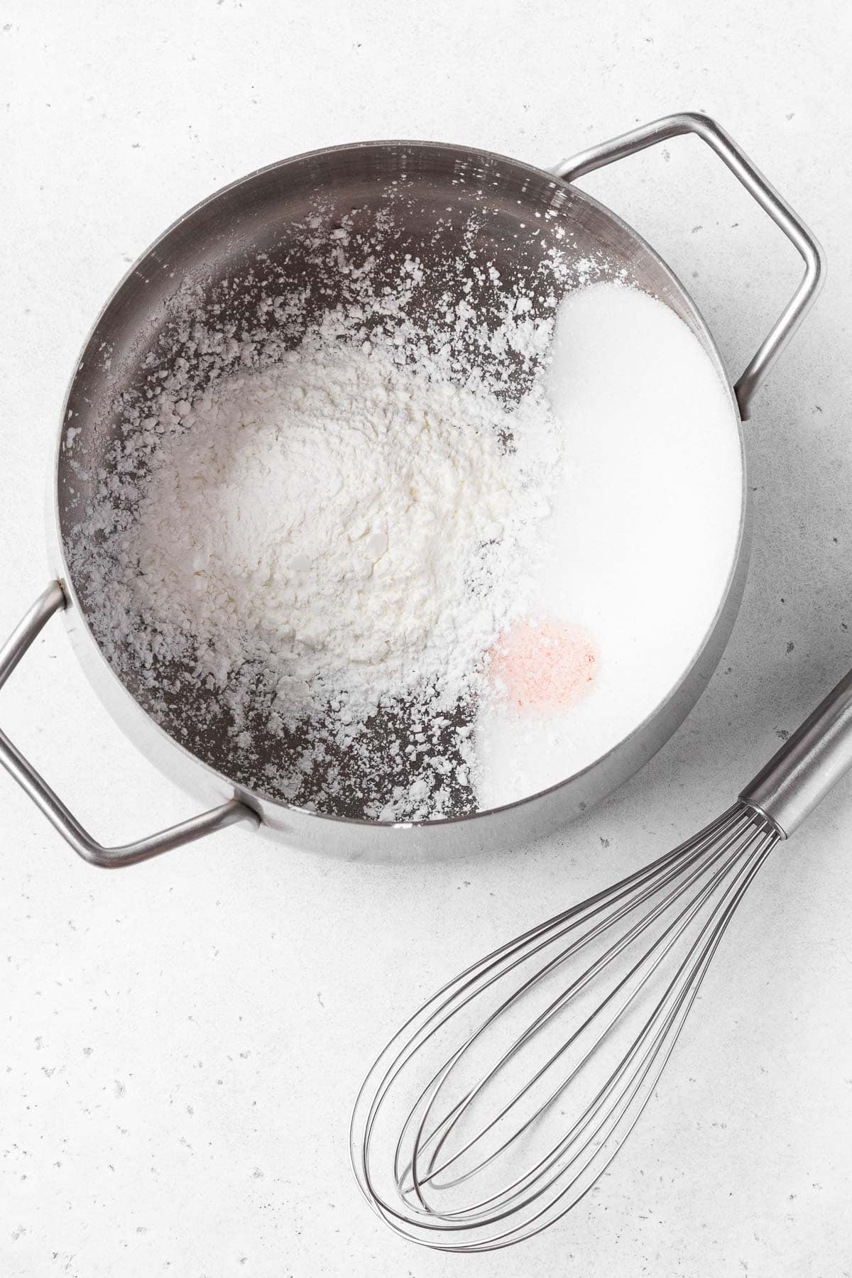 Dry ingredients for making vegan coconut pie filling in a saucepan.