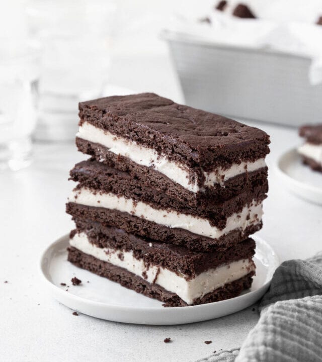A stack of gluten-free ice cream sandwich cookies on a white dish.