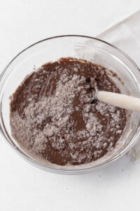Stirring the dry gluten-free whoopie pie ingredients into the wet ingredients.