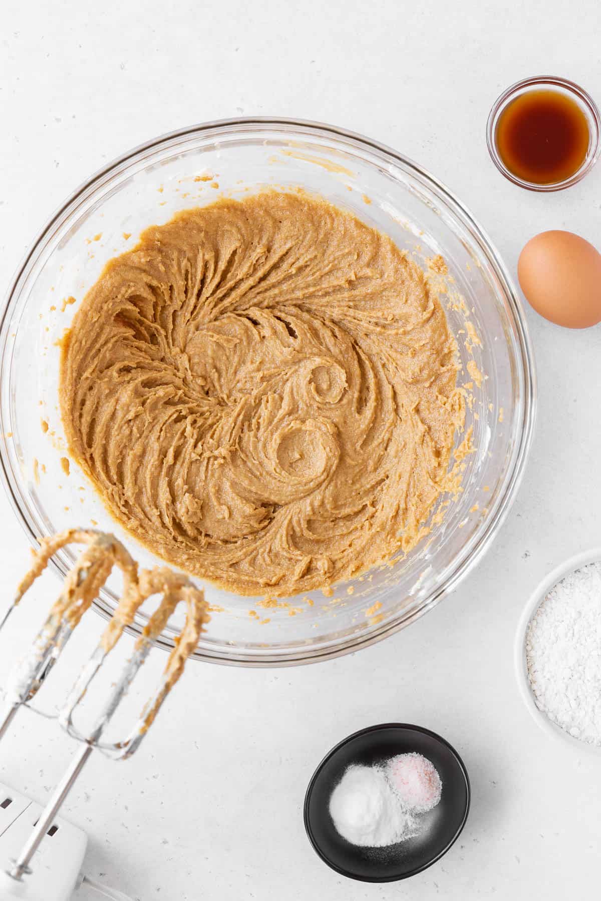 Blending the peanut butter and butter together in a glass mixing bowl. 