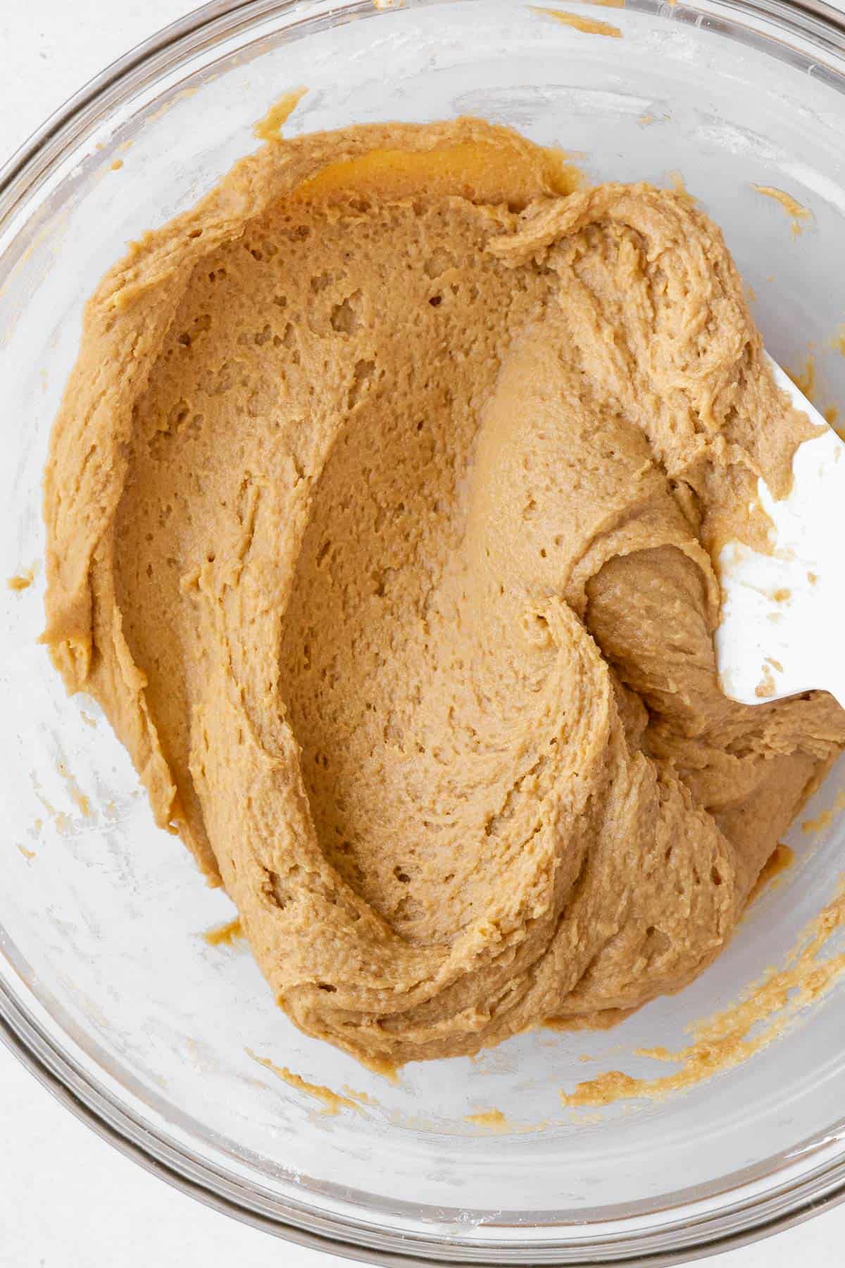 A closeup of the dairy-free peanut butter cookie dough in a mixing bowl.