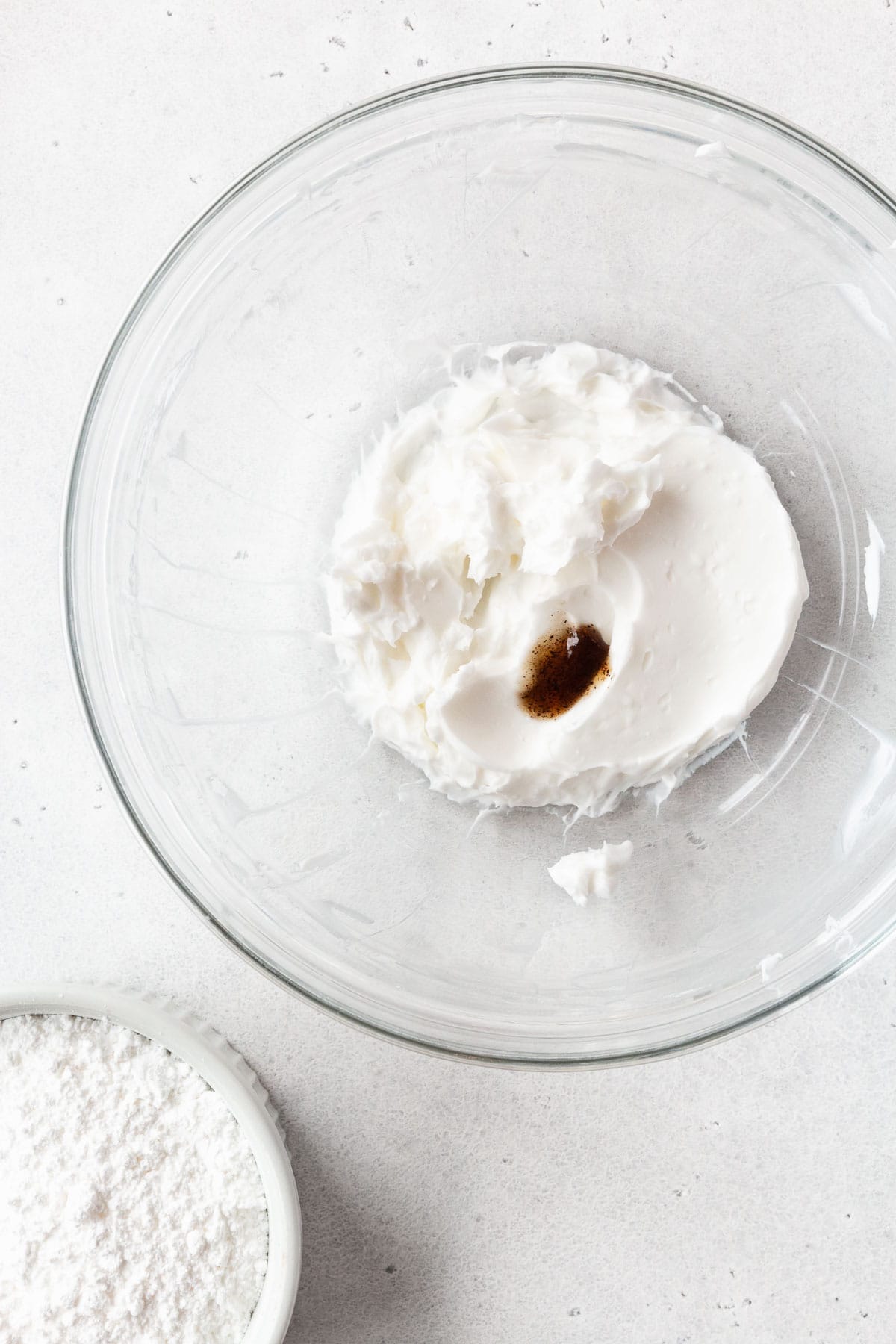 All of the cream cheese glaze ingredients in a glass mixing bowl.