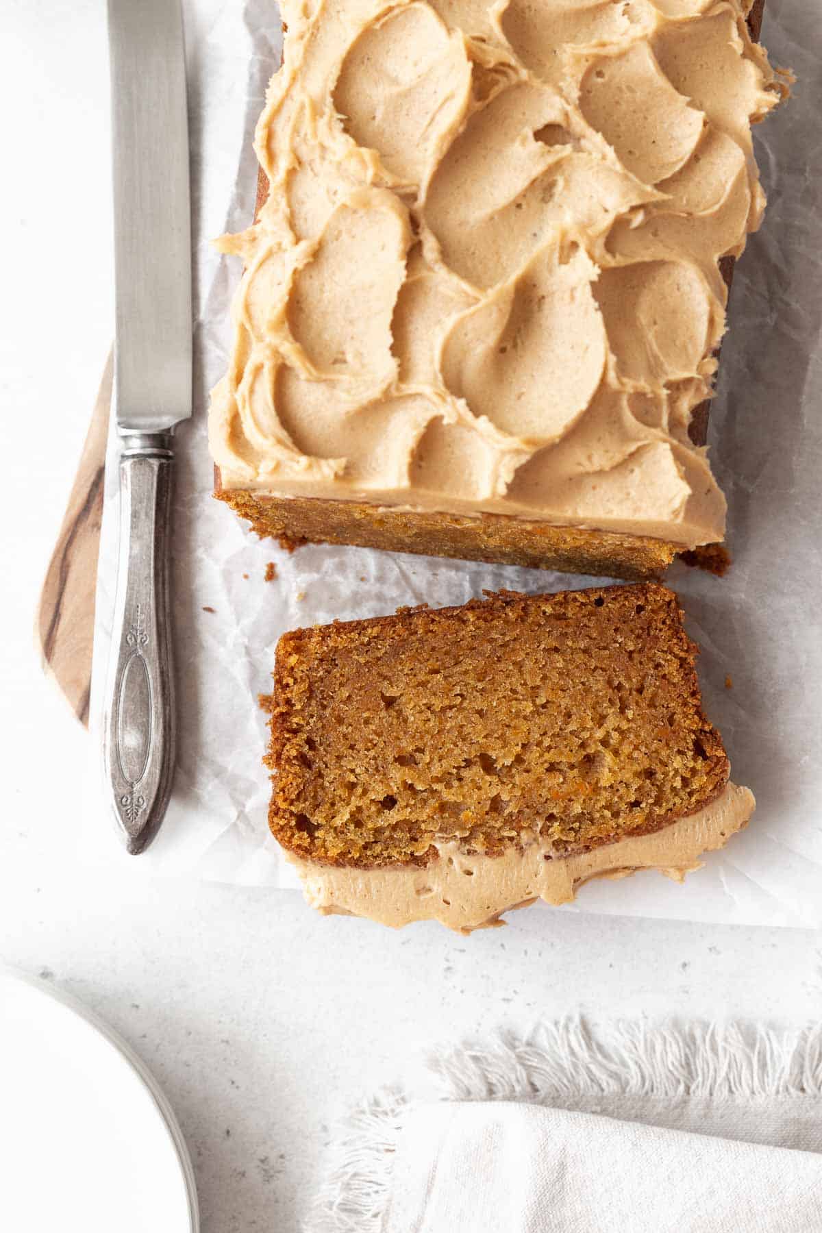 An overhead shot of sweet potato cake with a piece sliced off.