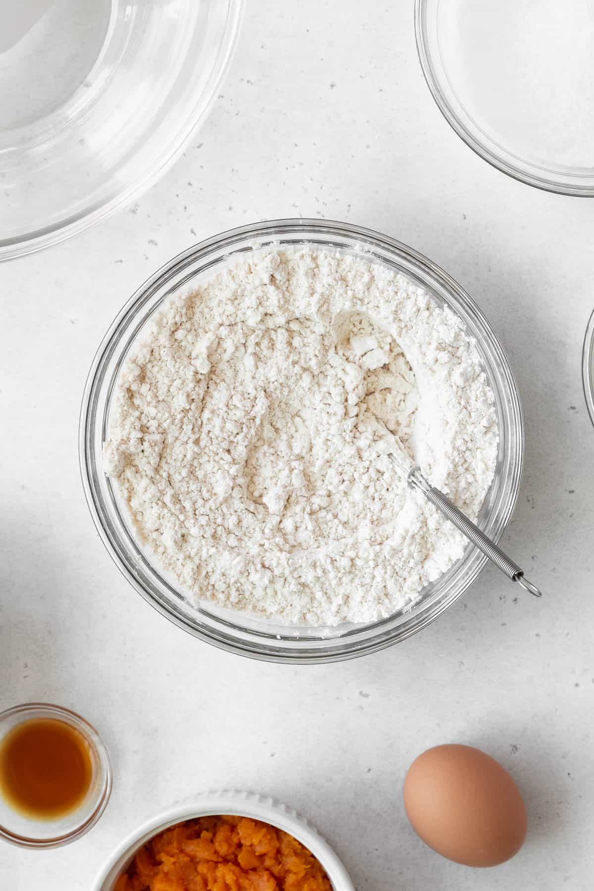 Mixed dry ingredients in a glass bowl.