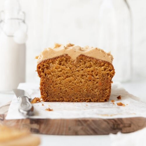 A square image of a sweet potato cake with cashew frosting.