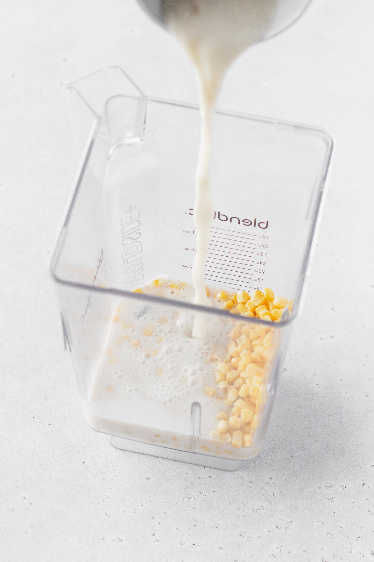 Corn and milk in a blender.