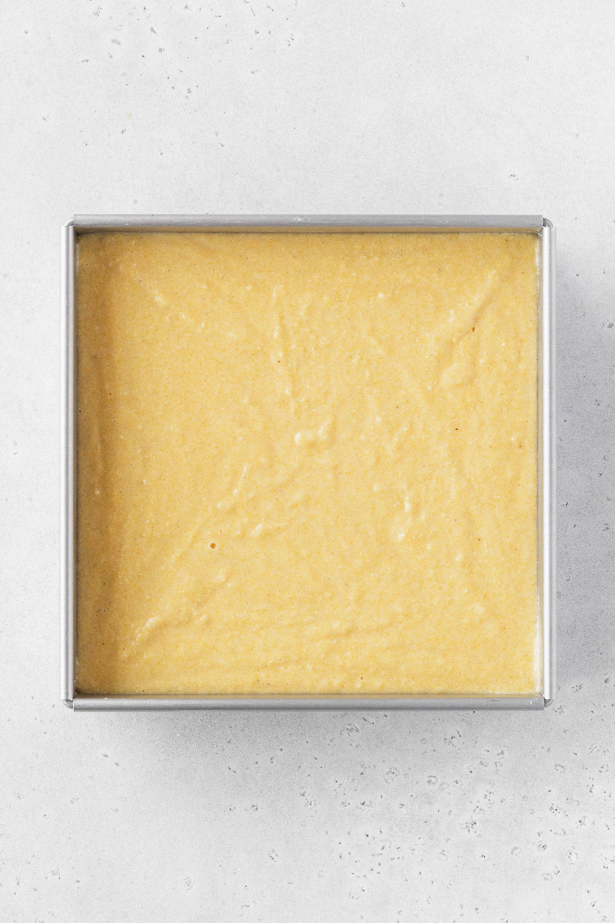 A pan of cornbread before going in the oven.