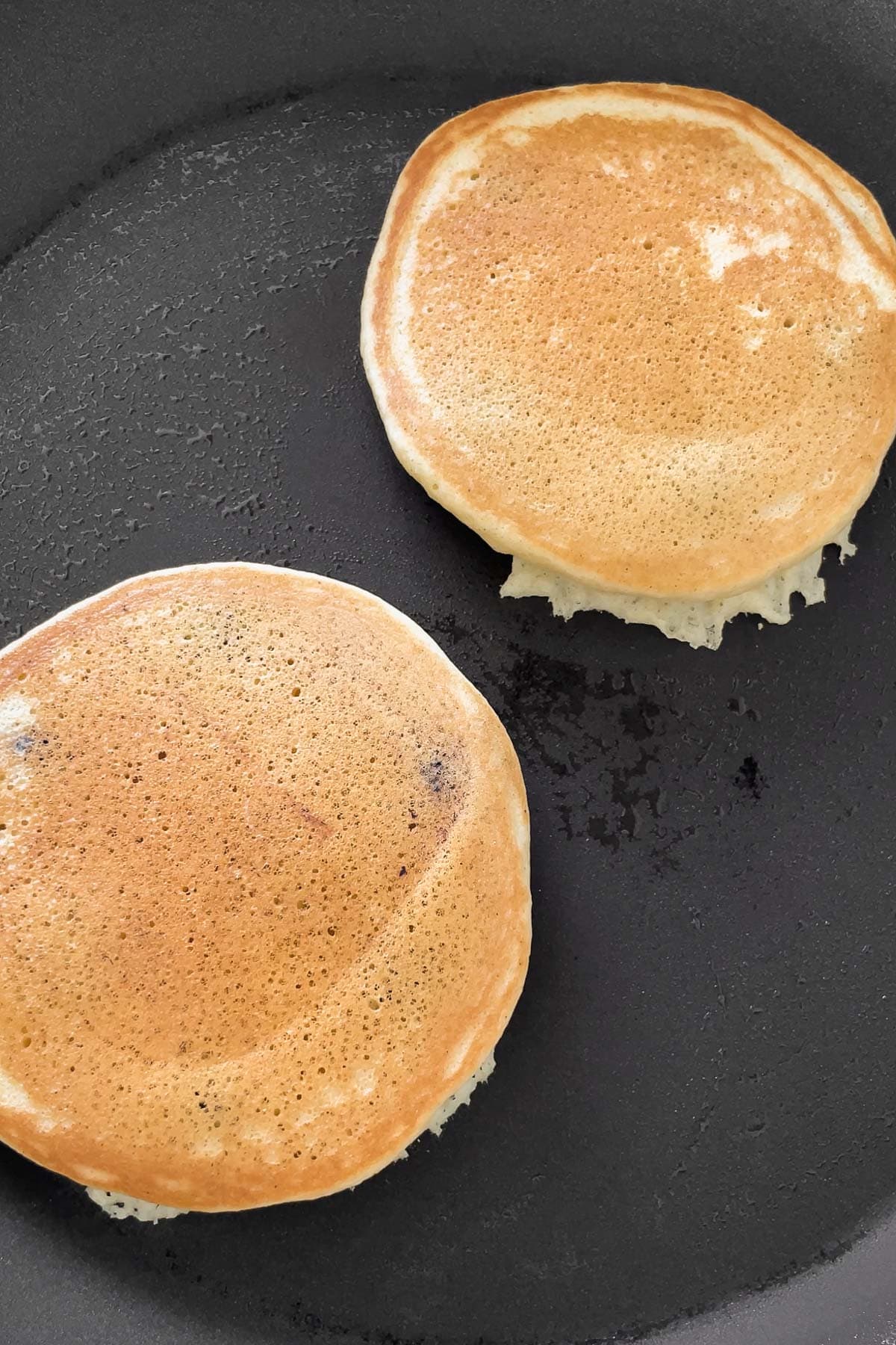 Process shot of the golden muffin mix pancakes after flipping in the skillet.