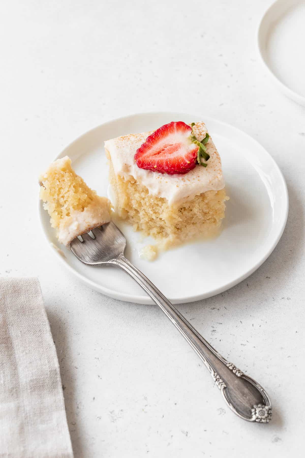 Taking a bite out of a piece of the gluten-free and dairy-free tres leches cake.